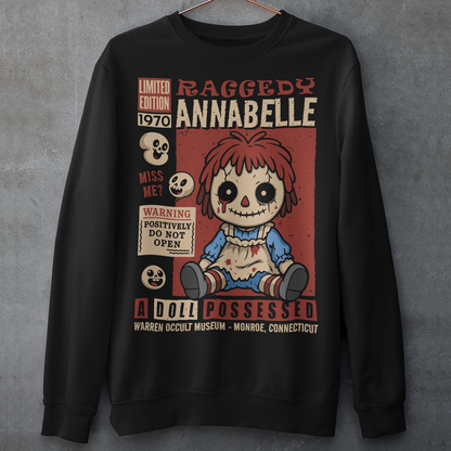 Stay cozy with a creepy-cute twist in this horror-themed sweatshirt featuring a distressed vintage doll design inspired by classic haunted-toy aesthetics. The graphic showcases a stitched, wide-eyed rag-style doll surrounded by spooky warning labels and retro horror elements, giving it the look of an old collectible poster. This shirt is ideal for horror fans, lovers of eerie artwork, and anyone who enjoys adding a little dark charm to their wardrobe.