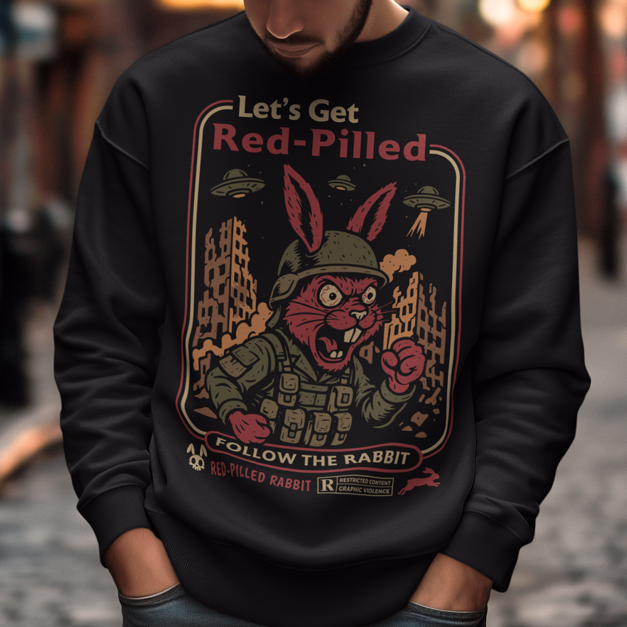 This black graphic sweatshirt dives headfirst down the rabbit hole. Featuring a fierce, red-eyed rabbit geared up like a rebel soldier, the design blends sci-fi paranoia, retro poster aesthetics, and counterculture attitude. Bold lettering reads “Let’s Get Red-Pilled” with “Follow the Rabbit” anchoring the scene, while crumbling cityscapes and hovering UFOs set a dystopian, mind-bending mood. This shirt feels like a lost propaganda poster from an alternate reality.