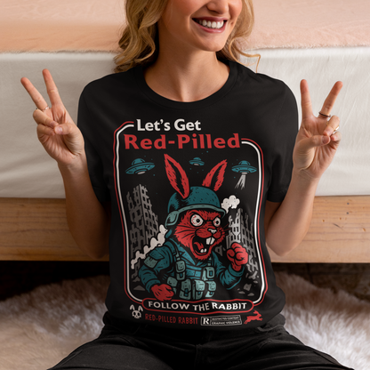 This black graphic tee dives headfirst down the rabbit hole. Featuring a fierce, red-eyed rabbit geared up like a rebel soldier, the design blends sci-fi paranoia, retro poster aesthetics, and counterculture attitude. Bold lettering reads “Let’s Get Red-Pilled” with “Follow the Rabbit” anchoring the scene, while crumbling cityscapes and hovering UFOs set a dystopian, mind-bending mood. This shirt feels like a lost propaganda poster from an alternate reality.