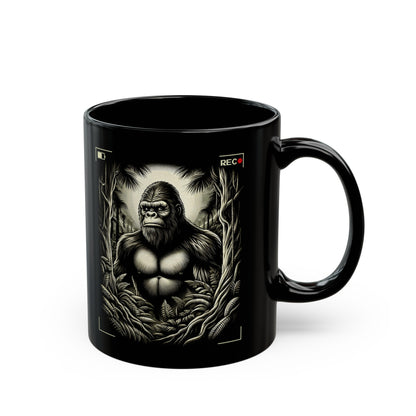 Black mug of Bigfoot being recorded looking through the trees.