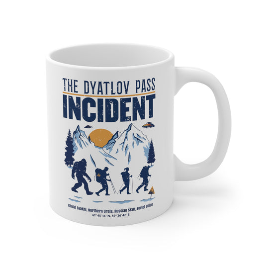 White mug of 3 hikers including Bigfoot in snowy mountains with UFOs and text THE DYATLOV PASS INCIDENT.