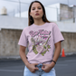 Pink t-shirt with a woman putting on lipstick surrounded by a rose, a microphone and a guitar with text above "ROSE-TINTED TUNES".