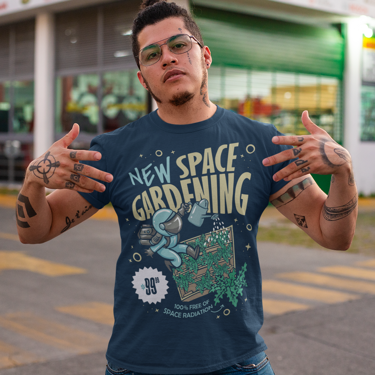 Navy t-shirt with space man gardening in space with text "NEW SPACE GARDENING"