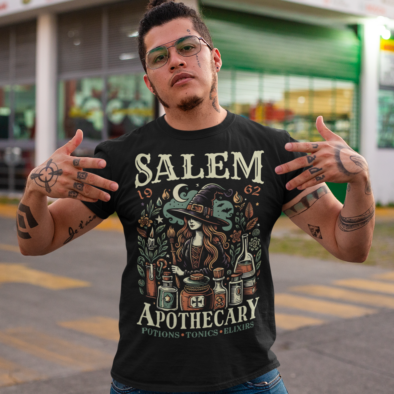 Black t-shirt of a Witch with potions and text SALEM APOTHECARY.