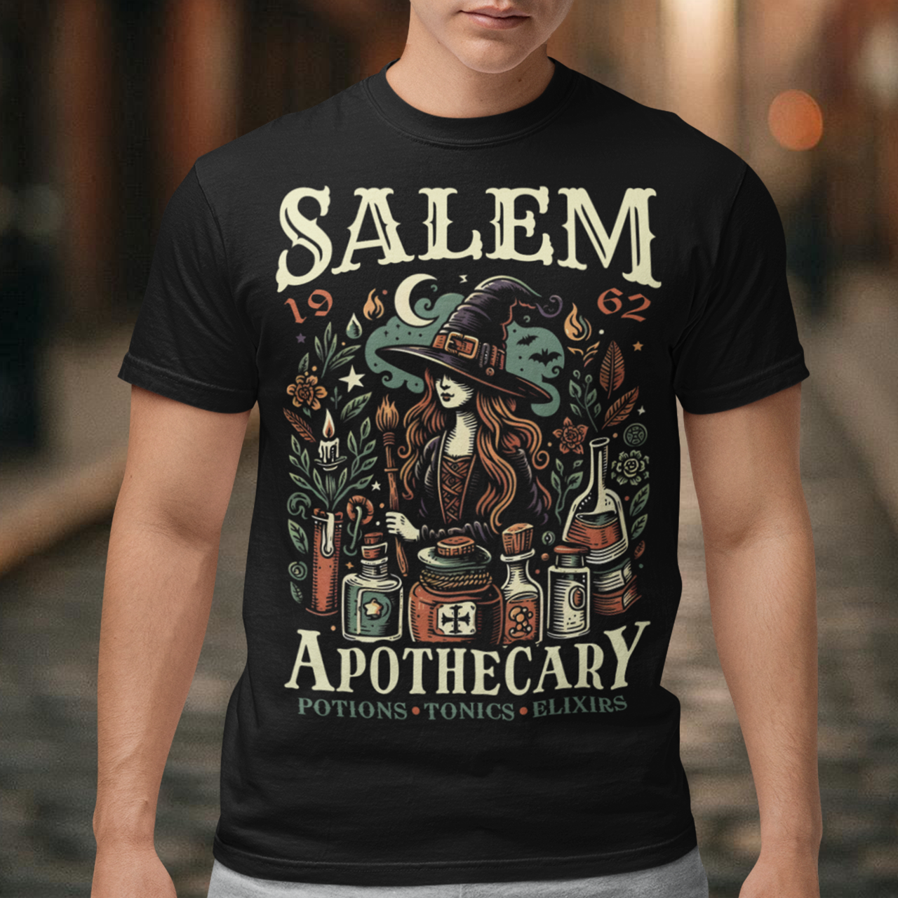 Step into the mystique of Salem with our "Salem Apothecary" t-shirt, a perfect blend of witchy charm and vintage flair. This design features a captivating witch, dressed in traditional attire, brewing potions with an array of mystical bottles and herbs. On the design the words "SALEM APOTHECARY" are prominently displayed, evoking the enchanting atmosphere of an old-world potion shop. This shirt is ideal for those who love the allure of witchcraft and the history of Salem.