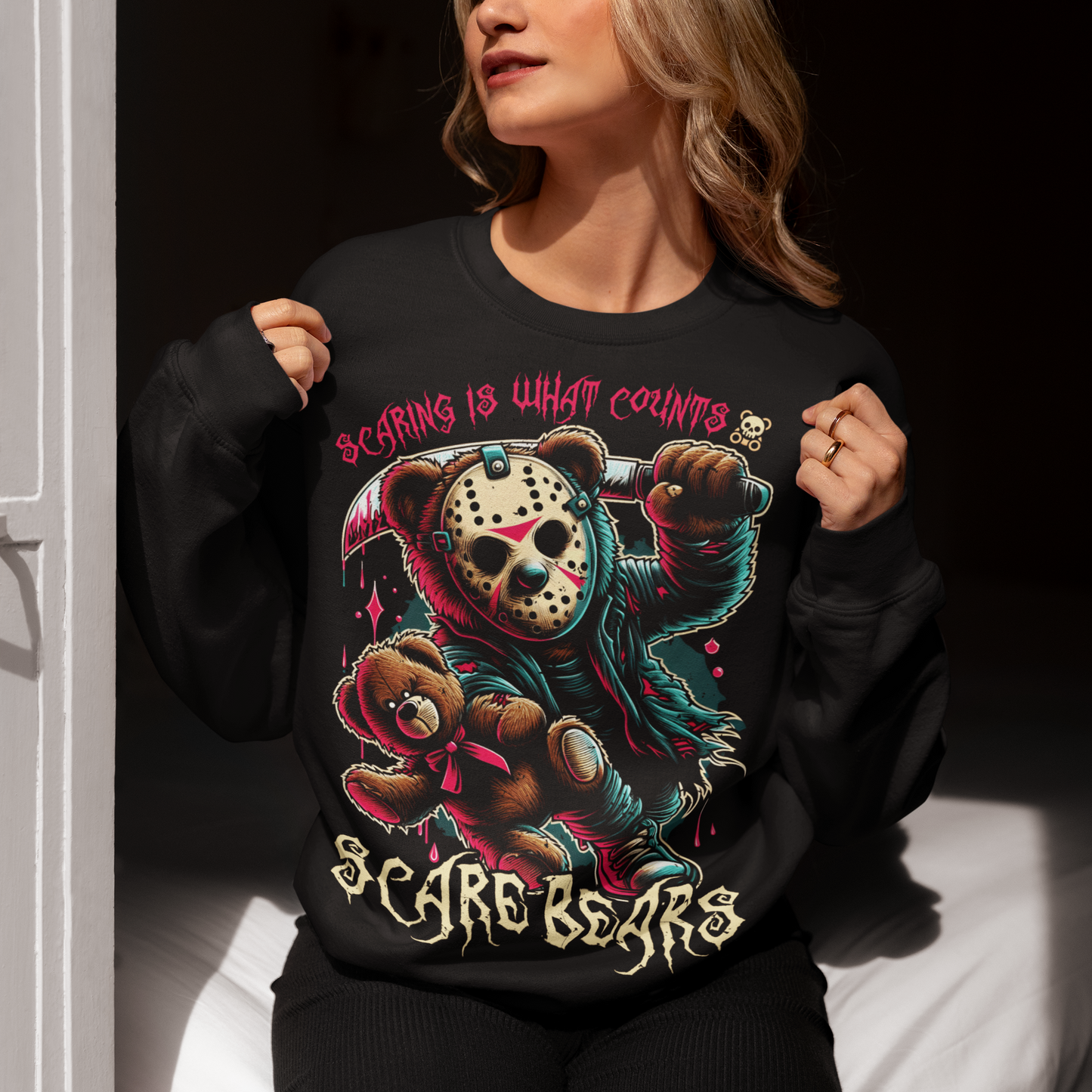 Black sweatshirt of a bear with a hockey mask and machete with text above "SCARING IS WHAT COUNTS". "Text below "SCARE BEARS".