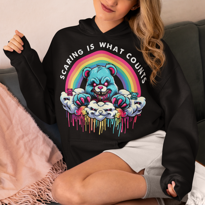 Black hoodie of scary bear on a cloud with a rainbow with text above "SCARING IS WHAT COUNTS".
