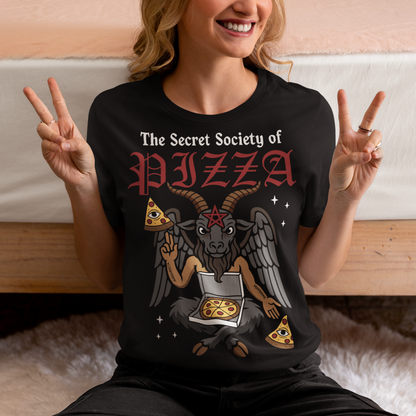 Black t-shirt featuring a humorous occult-style design with the text “The Secret Society of Pizza.” Artwork shows a winged goat figure with horns and a pentagram holding pizza slices and an open pizza box, surrounded by small stars. Gothic lettering and playful dark humor create a spooky pizza-themed graphic tee design.