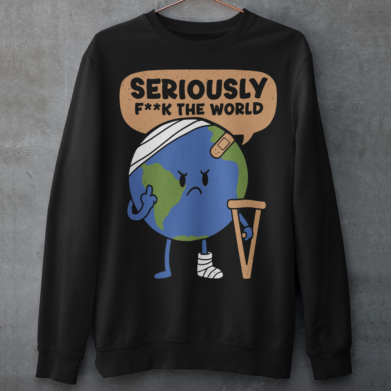 Black sweatshirt featuring a funny cartoon Earth character with bandages, crutches, and an angry face flipping the middle finger. Above the character is the text “Seriously F**k The World” in bold lettering. The design uses bright blue and green Earth colors against a black shirt for a dark humor, sarcastic graphic shirt style.