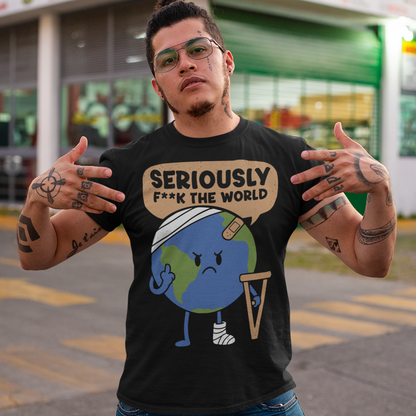 Black t-shirt featuring a funny cartoon Earth character with bandages, crutches, and an angry face flipping the middle finger. Above the character is the text “Seriously F**k The World” in bold lettering. The design uses bright blue and green Earth colors against a black shirt for a dark humor, sarcastic graphic tee style.