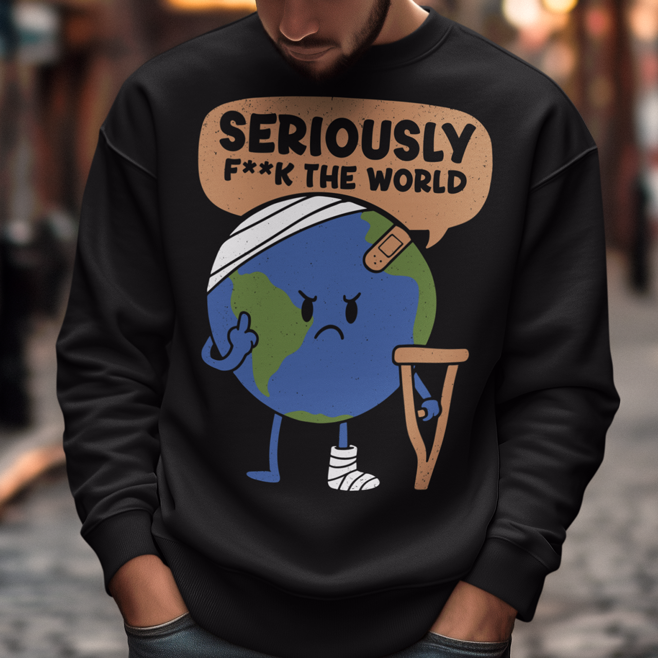 Black sweatshirt featuring a funny cartoon Earth character with bandages, crutches, and an angry face flipping the middle finger. Above the character is the text “Seriously F**k The World” in bold lettering. The design uses bright blue and green Earth colors against a black shirt for a dark humor, sarcastic graphic shirt style.