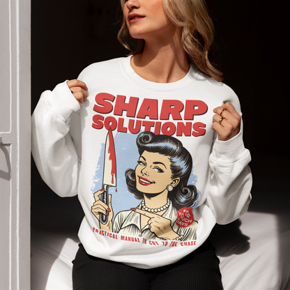 Slice through the stress of everyday life with this bold and cheeky “Sharp Solutions” retro-style Sweatshirt. Designed in a classic vintage aesthetic, it features a 1950s housewife confidently holding a dripping knife with a charming smile, paired with tongue-in-cheek text that adds the perfect dose of dark humor. Ideal for fans of edgy throwback art, sarcastic designs, and quirky graphic tees, this shirt makes a standout gift and a fun conversation starter wherever you wear it.