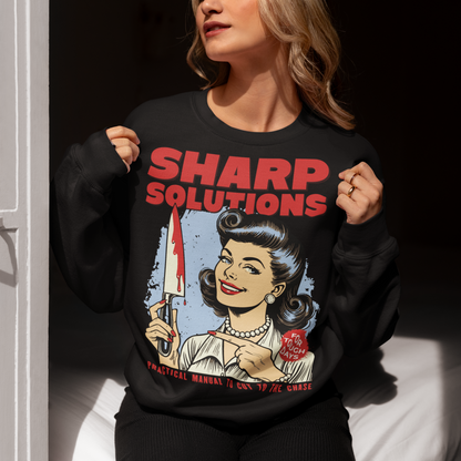Slice through the stress of everyday life with this bold and cheeky “Sharp Solutions” retro-style Sweatshirt. Designed in a classic vintage aesthetic, it features a 1950s housewife confidently holding a dripping knife with a charming smile, paired with tongue-in-cheek text that adds the perfect dose of dark humor. Ideal for fans of edgy throwback art, sarcastic designs, and quirky graphic tees, this shirt makes a standout gift and a fun conversation starter wherever you wear it.