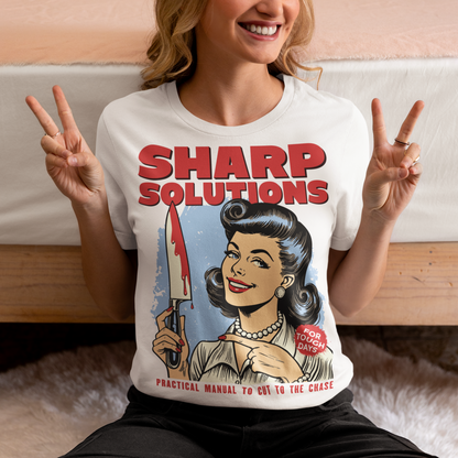Slice through the stress of everyday life with this bold and cheeky “Sharp Solutions” retro-style T-shirt. Designed in a classic vintage aesthetic, it features a 1950s housewife confidently holding a dripping knife with a charming smile, paired with tongue-in-cheek text that adds the perfect dose of dark humor. Ideal for fans of edgy throwback art, sarcastic designs, and quirky graphic tees, this shirt makes a standout gift and a fun conversation starter wherever you wear it.