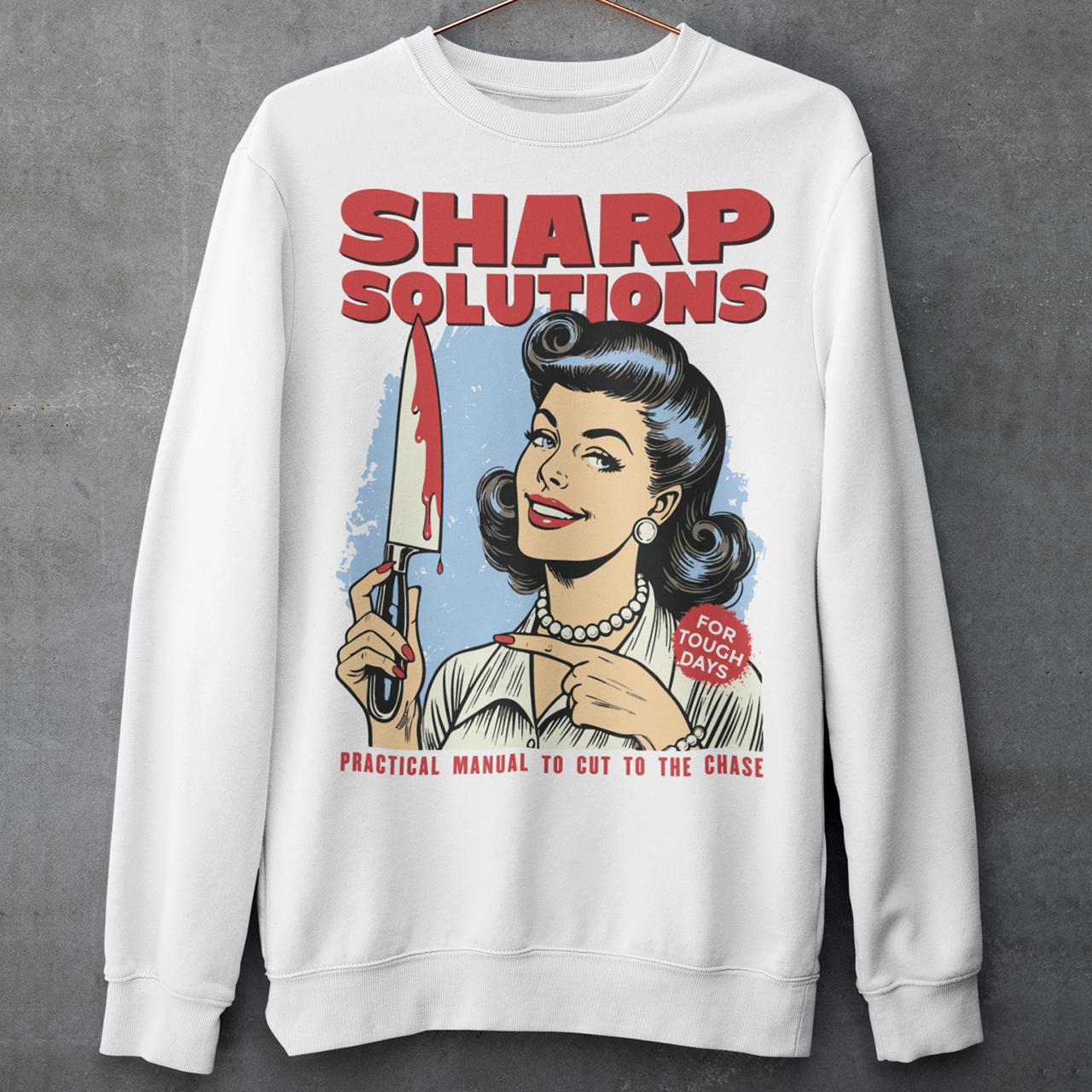 Slice through the stress of everyday life with this bold and cheeky “Sharp Solutions” retro-style Sweatshirt. Designed in a classic vintage aesthetic, it features a 1950s housewife confidently holding a dripping knife with a charming smile, paired with tongue-in-cheek text that adds the perfect dose of dark humor. Ideal for fans of edgy throwback art, sarcastic designs, and quirky graphic tees, this shirt makes a standout gift and a fun conversation starter wherever you wear it.