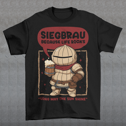 Black t-shirt featuring a cute, chibi-style armored knight Siegmeyer of Catarina holding a frothy beer mug. Above the character, bold text reads “Siegbrau because life rocks,” with smaller text below saying “Long may the sun shine.” The design has a playful fantasy theme with soft red tones and a hand-drawn style, appealing to gamers and fans of medieval or RPG-inspired humor.