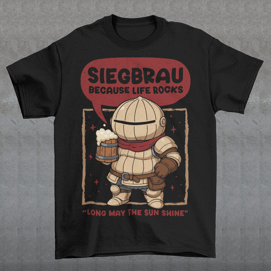 Black t-shirt featuring a cute, chibi-style armored knight Siegmeyer of Catarina holding a frothy beer mug. Above the character, bold text reads “Siegbrau because life rocks,” with smaller text below saying “Long may the sun shine.” The design has a playful fantasy theme with soft red tones and a hand-drawn style, appealing to gamers and fans of medieval or RPG-inspired humor.
