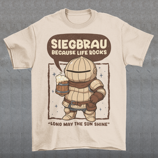 Beige t-shirt featuring a cute, chibi-style armored knight Siegmeyer of Catarina holding a frothy beer mug. Above the character, bold text reads “Siegbrau because life rocks,” with smaller text below saying “Long may the sun shine.” The design has a playful fantasy theme with soft brown tones and a hand-drawn style, appealing to gamers and fans of medieval or RPG-inspired humor.