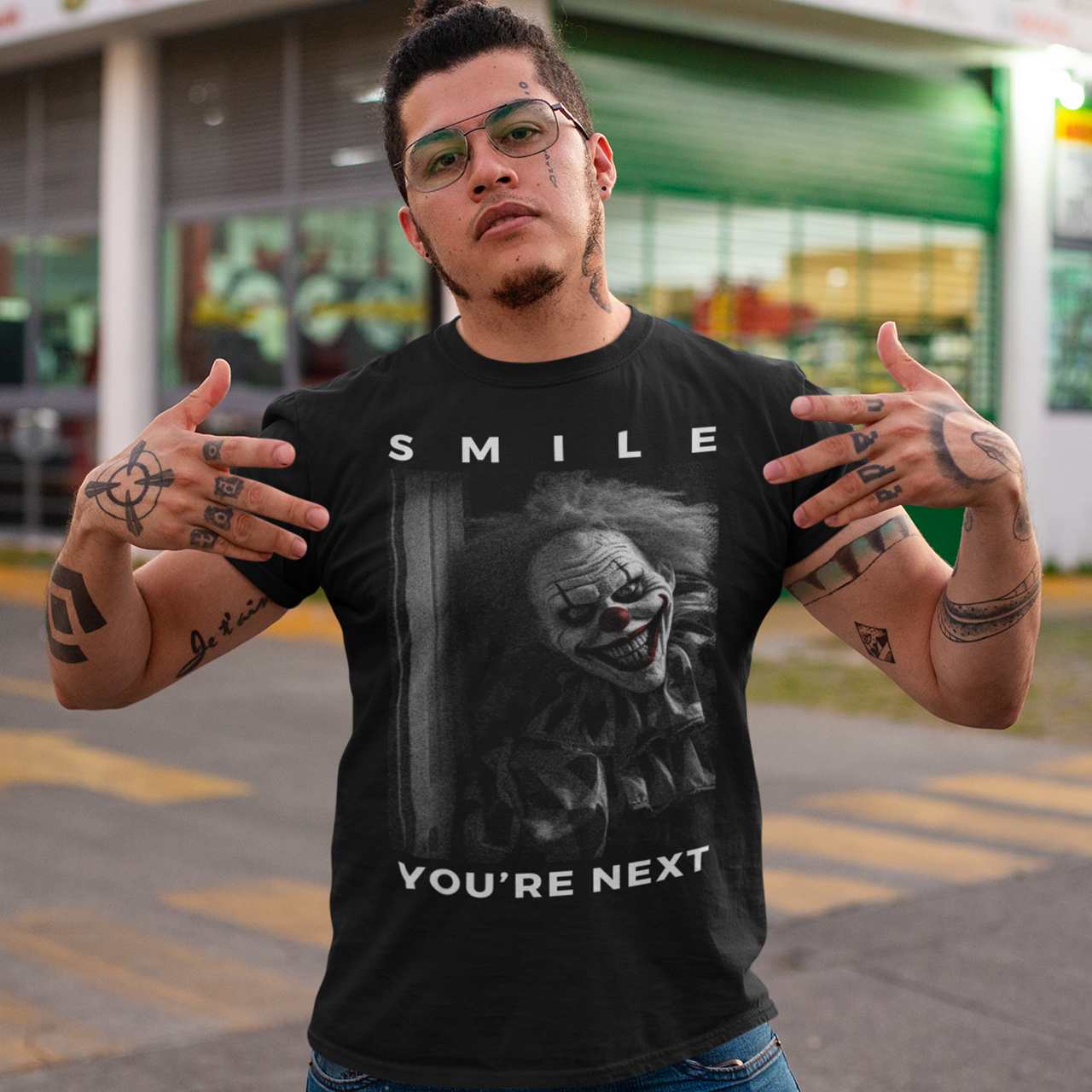 Black t-shirt of a grinning killer clown with text "SMILE YOU'RE NEXT".