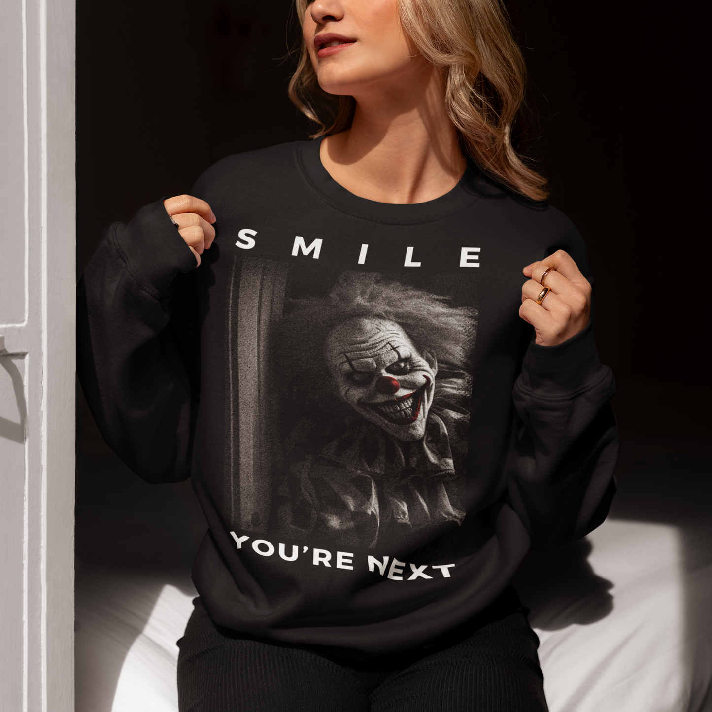 Black sweatshirt of a killer clown with text SMILE YOURE NEXT.