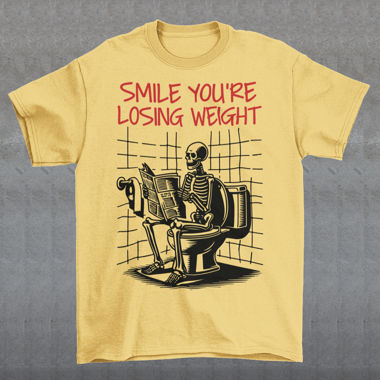 A humorous t-shirt design featuring a cartoon skeleton sitting on a toilet, legs crossed, casually reading a newspaper. The skeleton has a relaxed, almost cheerful expression, emphasizing the absurdity of the scene. Above the image, bold text reads: "SMILE YOU'RE LOSING WEIGHT," playing on the double meaning of weight loss and the skeleton’s bony frame. The design blends bathroom humor with ironic positivity for a lighthearted laugh.