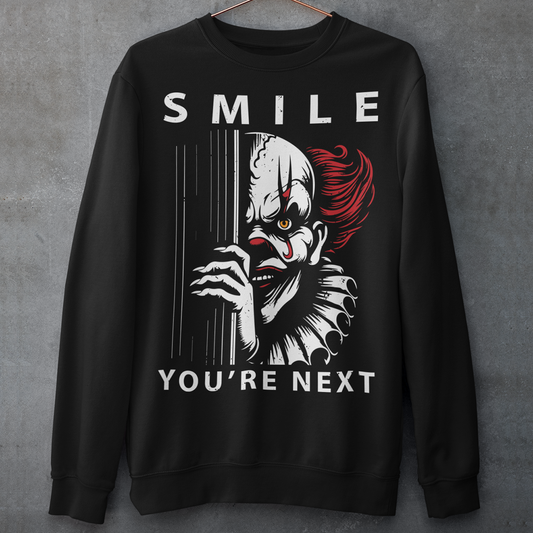 Introducing our chillingly captivating sweatshirt design, "SMILE YOU'RE NEXT." This bone-chilling masterpiece features a sinister, grinning killer clown, designed to send shivers down your spine. The intricate details of the clown's malevolent expression are both mesmerizing and haunting, drawing you into the depths of its dark persona.