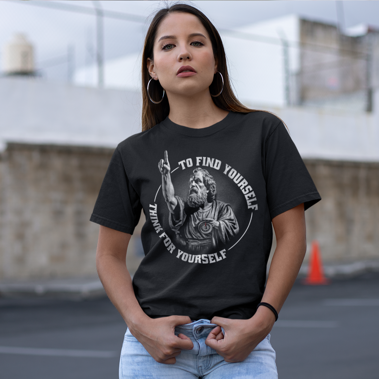 Black t-shirt of Socrates holding his finger up and holding a compass with text around TO FIND YOURSELF THINK FOR YOURSELF.