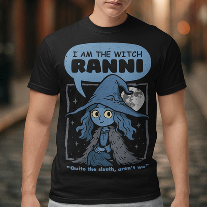 Black t-shirt featuring a cute blue witch character with large eyes wearing a pointed hat and cloak, set against a night sky with a full moon and stars. Text above reads “I AM THE WITCH RANNI,” with a smaller quote below saying “Quite the sleuth, aren’t we.” The design has a dark fantasy, game-inspired style with soft blue tones and a whimsical, mystical aesthetic.