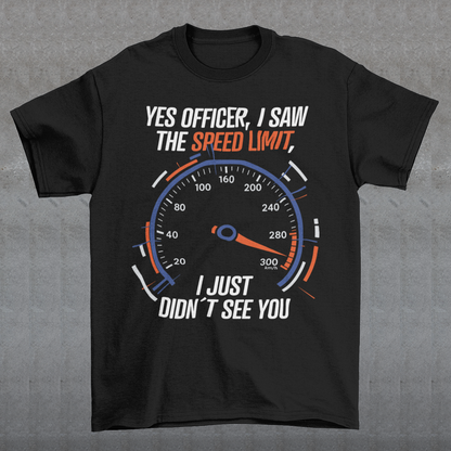 Black t-shirt featuring a bold speedometer graphic with the text “YES OFFICER, I SAW THE SPEED LIMIT, I JUST DIDN’T SEE YOU.” The design uses white, orange, and blue lettering and accents, with a large speed gauge showing speeds up to 300 km/h. Funny driving and car enthusiast themed graphic.
