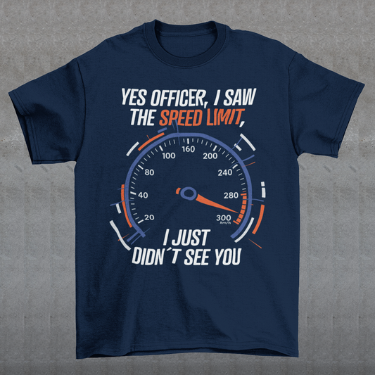 Navy blue t-shirt featuring a bold speedometer graphic with the text “YES OFFICER, I SAW THE SPEED LIMIT, I JUST DIDN’T SEE YOU.” The design uses white, orange, and blue lettering and accents, with a large speed gauge showing speeds up to 300 km/h. Funny driving and car enthusiast themed graphic.
