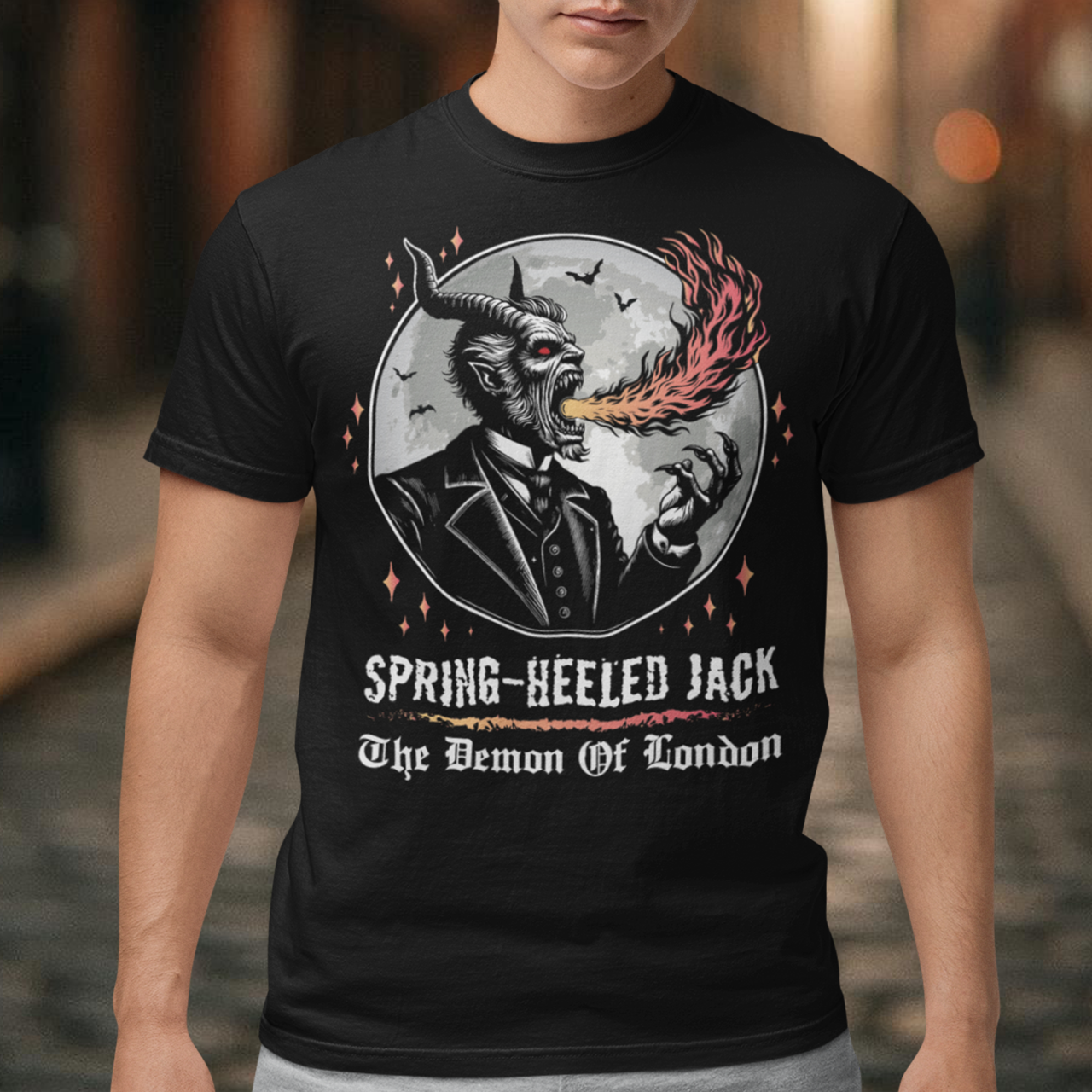 Introducing our electrifying Spring-heeled Jack t-shirt, a striking fusion of folklore and urban legend! Against the backdrop of a hauntingly illuminated moon, Spring-heeled Jack leaps into action, exhaling flames with an otherworldly flair. This enigmatic figure, shrouded in mystery and mischief, has long captured the imagination of Londoners and beyond. With intricate detail and bold colors, our design brings to life the infamous character known as the "Demon of London.