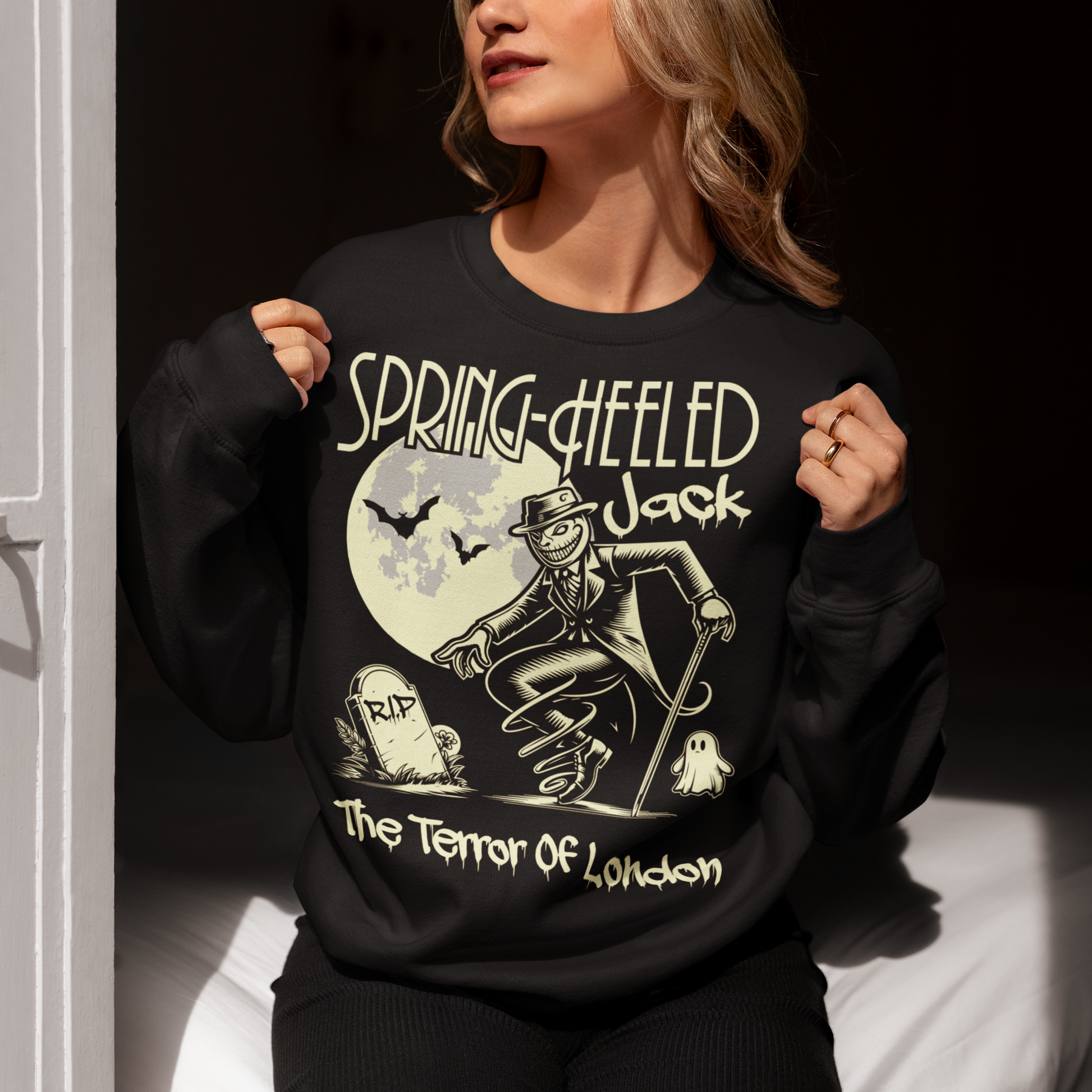 At the center of this striking sweatshirt design stands Spring-heeled Jack, the enigmatic figure of Victorian urban legend. Rendered in bold lines and vibrant colors, Spring-heeled Jack exudes an air of mystery and menace. His elongated figure seems to leap from the fabric, his eyes gleaming with an otherworldly intensity.