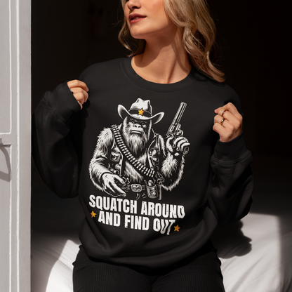 Introducing the "Squatch Around And Find Out" sweatshirt, where the legend of the wild west meets the mystery of the elusive Sasquatch! Picture this: a rugged, majestic Sasquatch, decked out in full cowboy gear, complete with a sheriff's badge and a trusty firearm at the ready. With a steely gaze and an air of authority, this Squatch means business. Beneath this formidable figure, the bold text reads: "SQUATCH AROUND AND FIND OUT."
