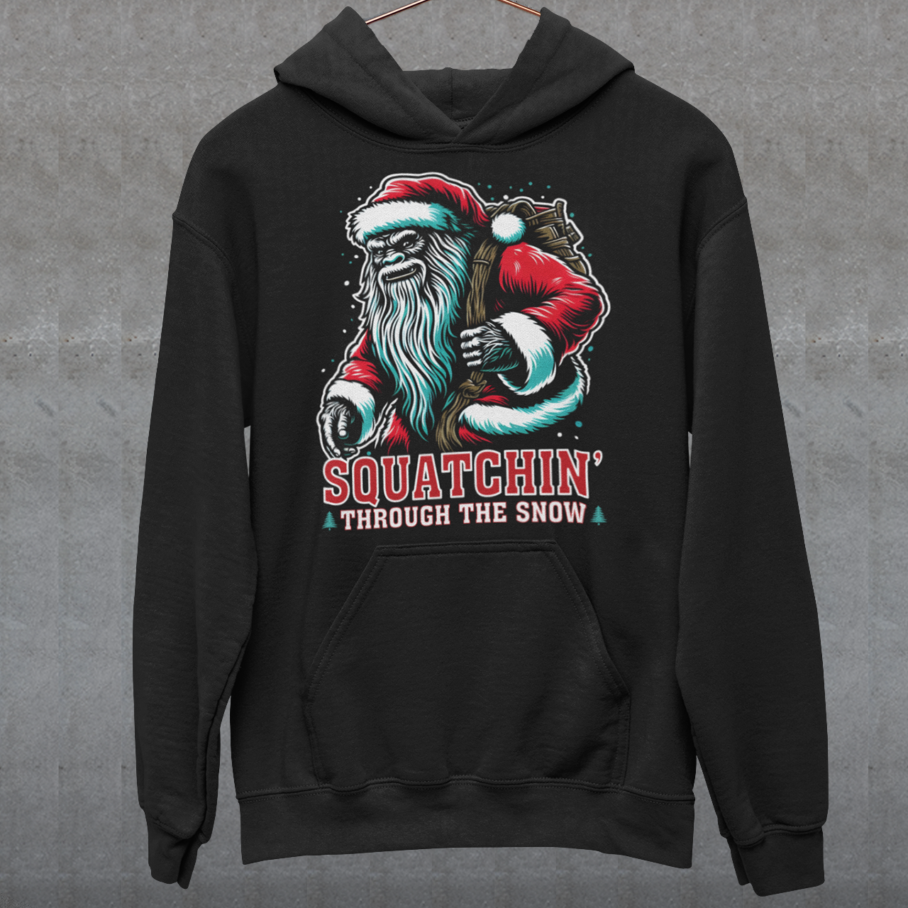 Black Christmas hoodie of a Santa sasquatch and text "Squatchin' through the snow."