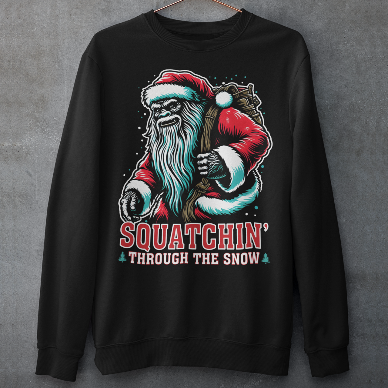 Black Christmas sweatshirt of a Santa sasquatch and text "Squatchin' through the snow."