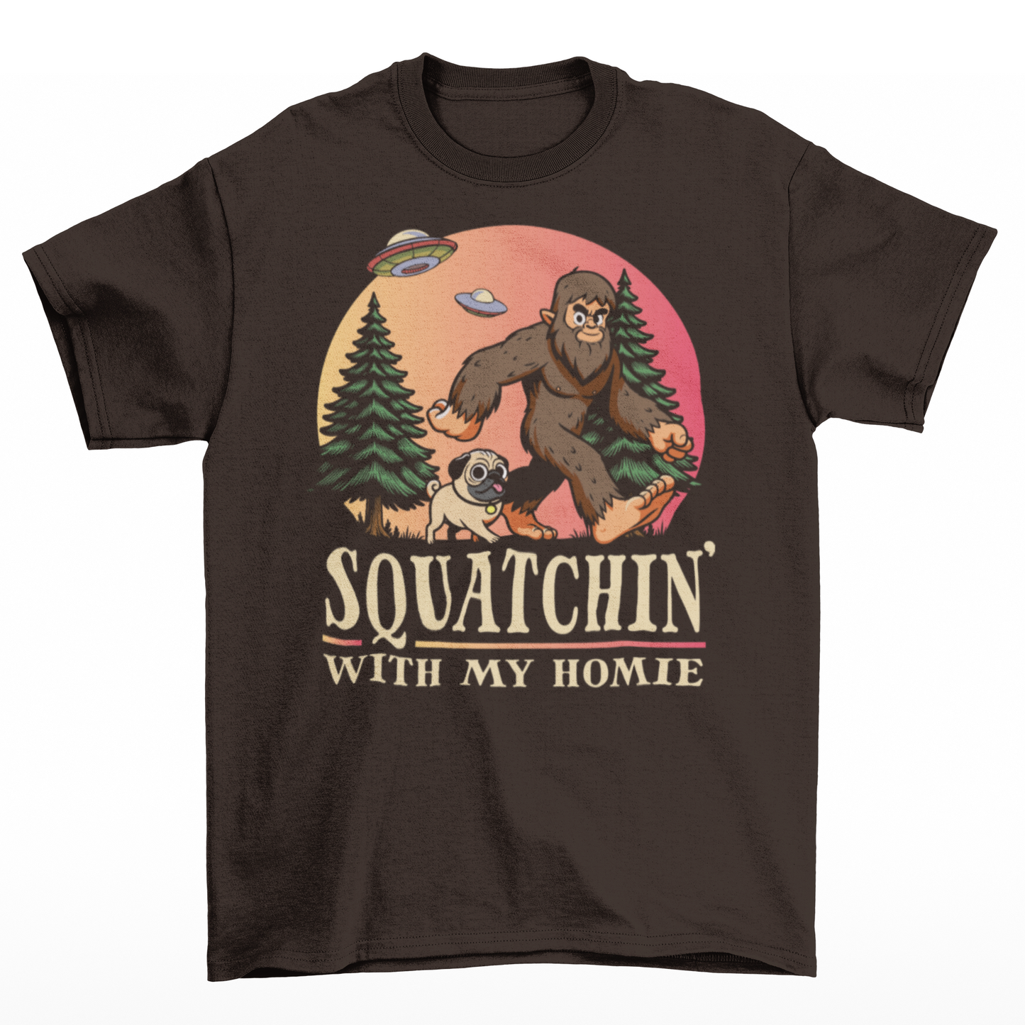 Brown t-shirt of Bigfoot hiking with his pug in the woods with UFOs in the sky with text underneath SQUATCHIN WITH MY HOMIE.