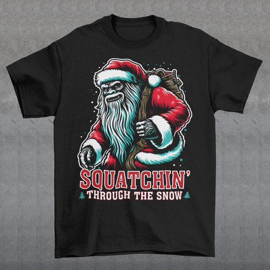 Get ready for holiday fun with our "Squatchin' Through the Snow" T-Shirt! This festive design features a whimsical Santa Sasquatch, decked out in a red Santa hat, strolling through a snowy forest. With his massive feet leaving tracks behind, he's the perfect mix of holiday spirit and mysterious wilderness charm.