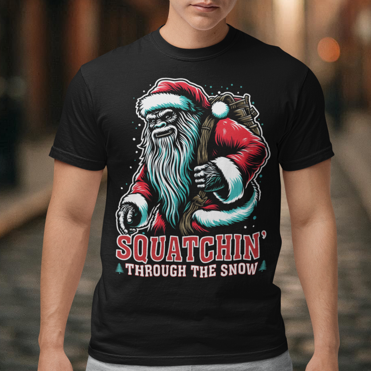 Get ready for holiday fun with our "Squatchin' Through the Snow" T-Shirt! This festive design features a whimsical Santa Sasquatch, decked out in a red Santa hat, strolling through a snowy forest. With his massive feet leaving tracks behind, he's the perfect mix of holiday spirit and mysterious wilderness charm.
