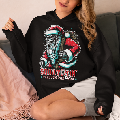 Black Christmas hoodie of a Santa sasquatch and text "Squatchin' through the snow."