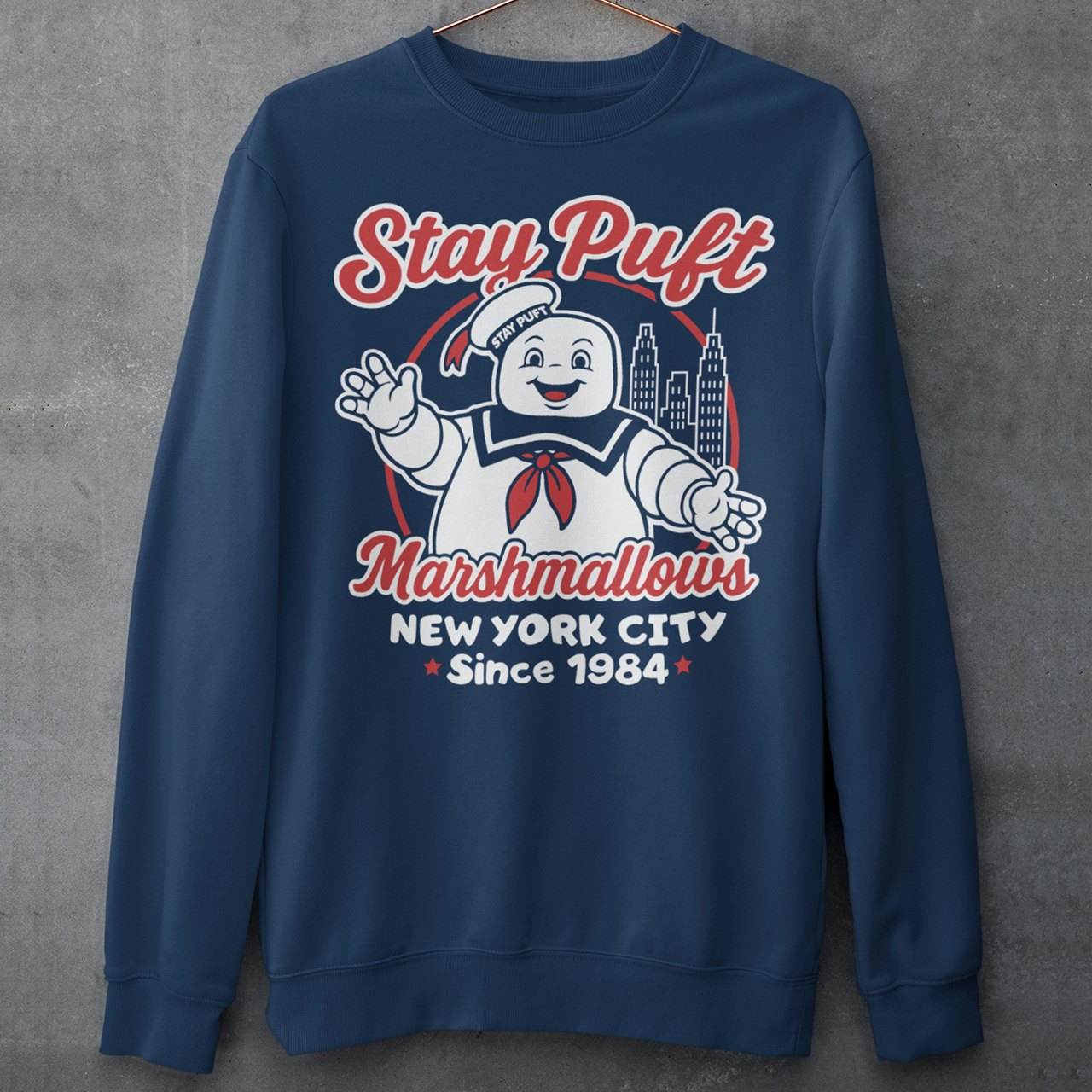 Bring some sweet nostalgia to your wardrobe with this Stay Puft Marshmallows Sweatshirt! Featuring the iconic Stay Puft Marshmallow Man, this design captures the perfect mix of charm and chaos. The bold text “Stay Puft Marshmallows” adds a vintage, retro-advertisement vibe — just like the classic 80s original.