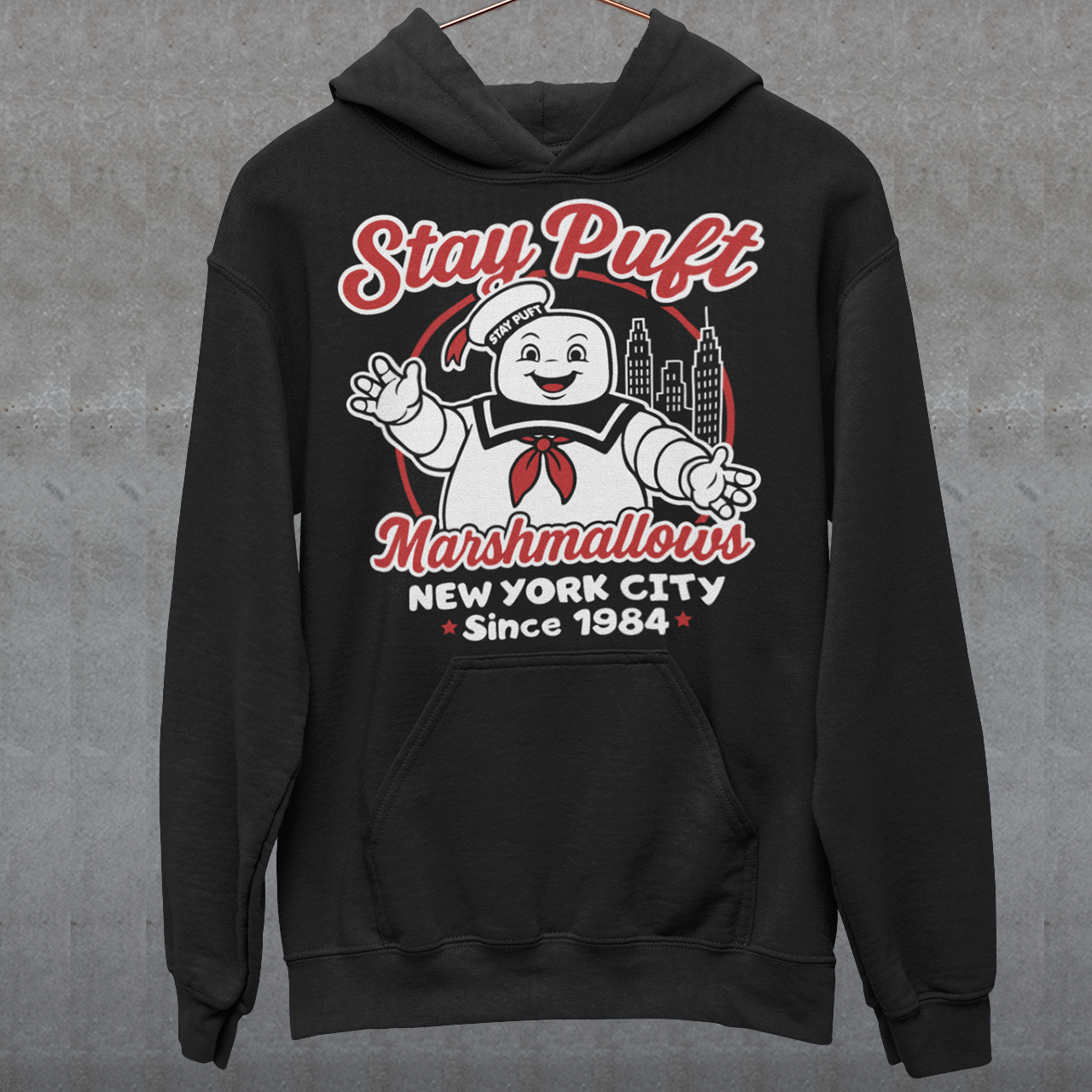 Bring some sweet nostalgia to your wardrobe with this Stay Puft Marshmallows Hoodie! Featuring the iconic Stay Puft Marshmallow Man, this design captures the perfect mix of charm and chaos. The bold text “Stay Puft Marshmallows” adds a vintage, retro-advertisement vibe — just like the classic 80s original.