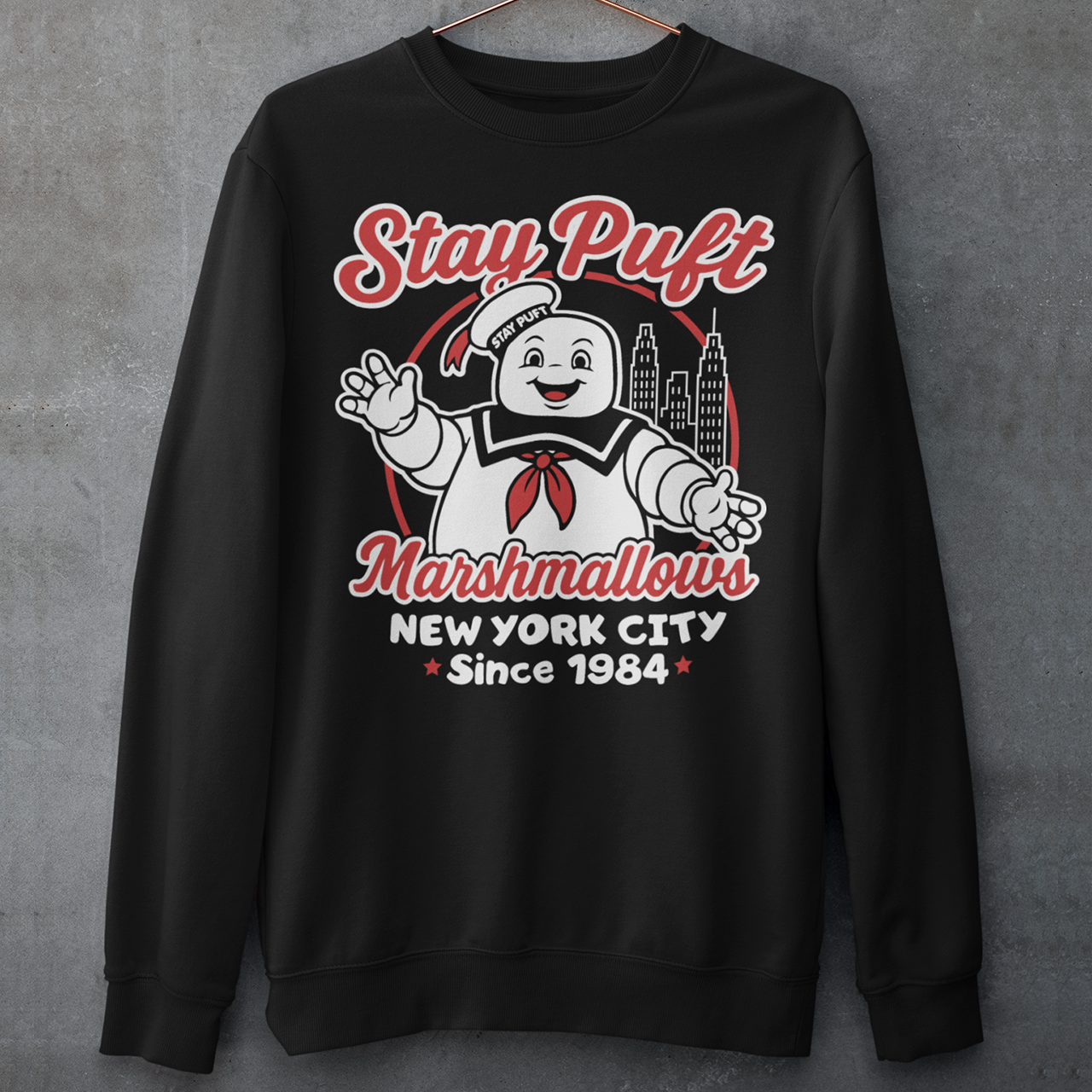 Bring some sweet nostalgia to your wardrobe with this Stay Puft Marshmallows Sweatshirt! Featuring the iconic Stay Puft Marshmallow Man, this design captures the perfect mix of charm and chaos. The bold text “Stay Puft Marshmallows” adds a vintage, retro-advertisement vibe — just like the classic 80s original.