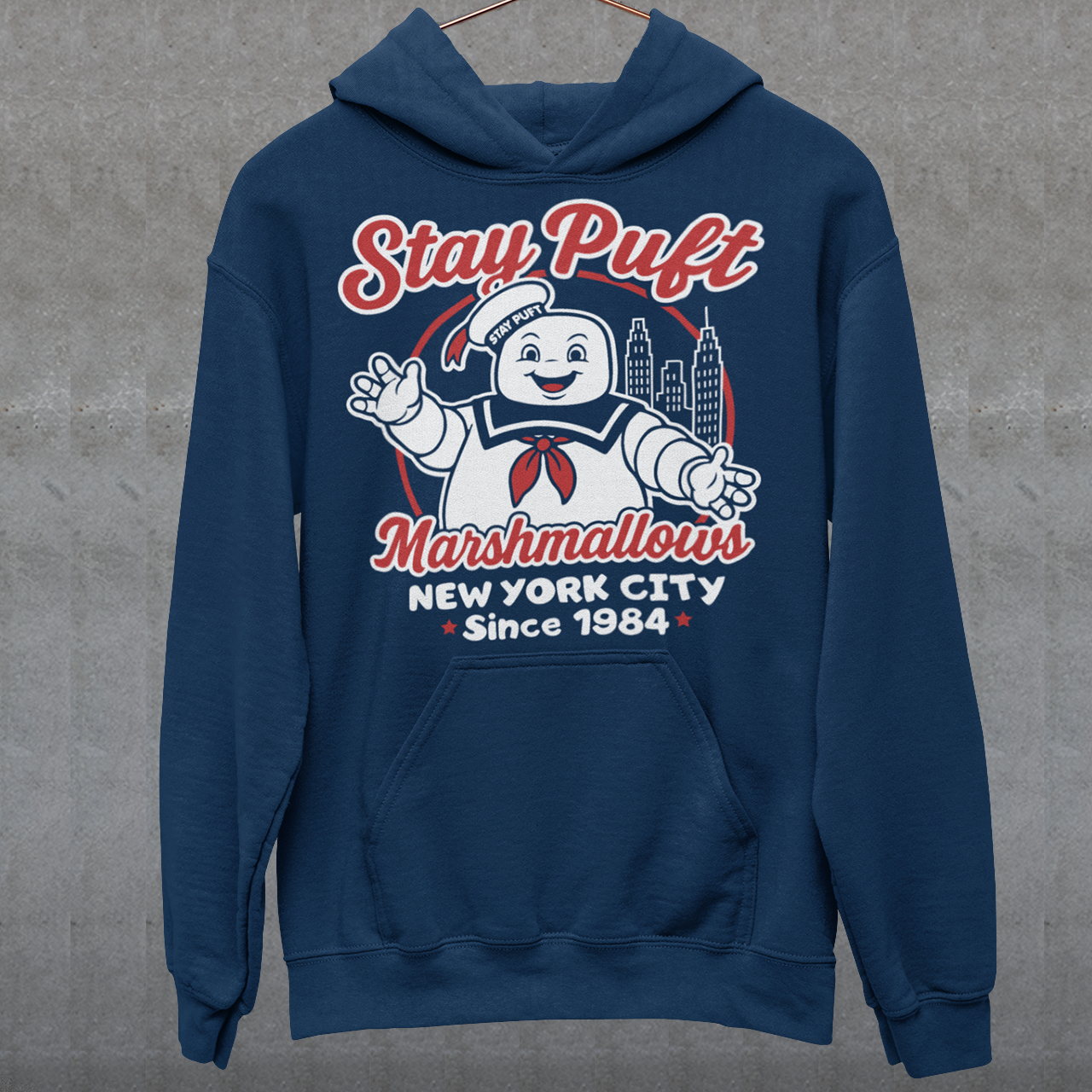 Bring some sweet nostalgia to your wardrobe with this Stay Puft Marshmallows Hoodie! Featuring the iconic Stay Puft Marshmallow Man, this design captures the perfect mix of charm and chaos. The bold text “Stay Puft Marshmallows” adds a vintage, retro-advertisement vibe — just like the classic 80s original.