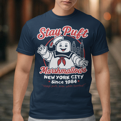 Bring some sweet nostalgia to your wardrobe with this Stay Puft Marshmallows T-Shirt! Featuring the iconic Stay Puft Marshmallow Man, this design captures the perfect mix of charm and chaos. The bold text “Stay Puft Marshmallows” adds a vintage, retro-advertisement vibe — just like the classic 80s original.