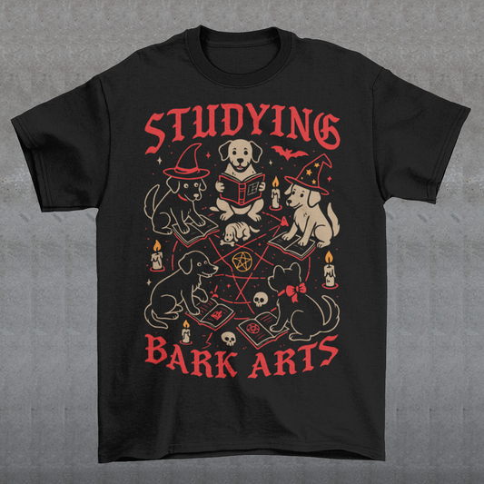 Studying The Bark Arts T-Shirt - Dark Arts Dog Shirt - Dog Lover Tee - Funny Pet Gift. Gather the cutest coven you’ve ever seen with this playful and spooky “Studying Bark Arts” t-shirt. Featuring a circle of adorable pups deep in magical study, this design blends witchy vibes with wholesome dog energy. From tiny spellbooks and glowing candles to pentagrams and wizard hats, every detail adds a charming twist to classic occult imagery, turning dark arts into pure, tail-wagging fun.