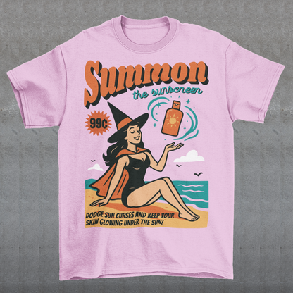 Bring a little magic to your summer with this whimsical tee! Featuring a playful illustration of a witch lounging on the shore, sunhat tilted and a bottle of sunscreen within arm’s reach, this design blends spooky charm with sunny vibes. Bold text above reads SUMMON THE SUNSCREEN in an enchanting font, making it perfect for anyone who loves both moonlit rituals and seaside relaxation.