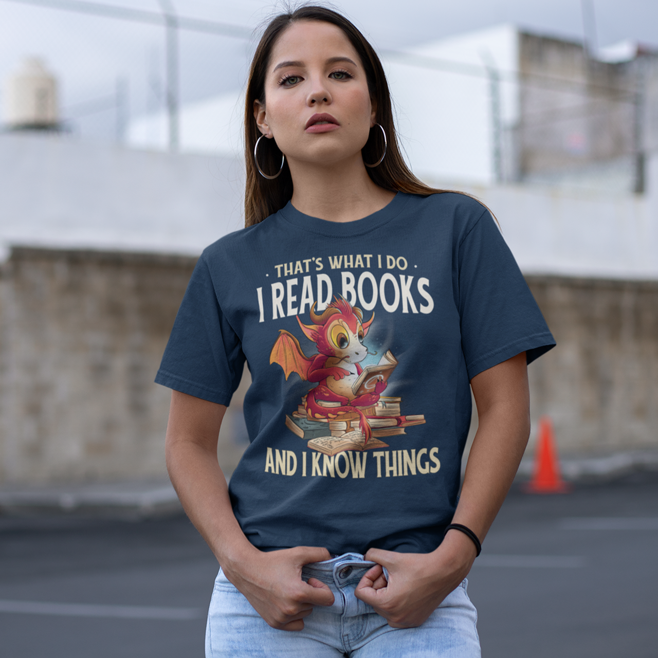 Navy t-shirt of a dragon reading books with text "THAT'S WHAT I DO I READ AND KNOW THINGS".