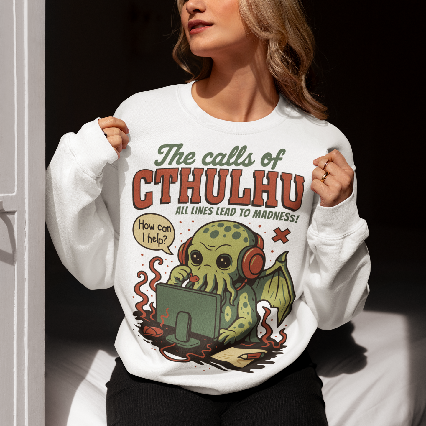 Answer the call of cosmic chaos with this irresistibly cute Cthulhu sweatshirt, where eldritch horror meets everyday office despair. Featuring everyone’s favorite ancient entity manning a help desk, headset on and sanity slipping, this design jokes that all lines eventually lead to madness. Soft, comfy, and packed with dark humor, it’s perfect for Lovecraft fans, RPG players, horror geeks, and anyone who’s ever worked customer support and stared into the abyss.