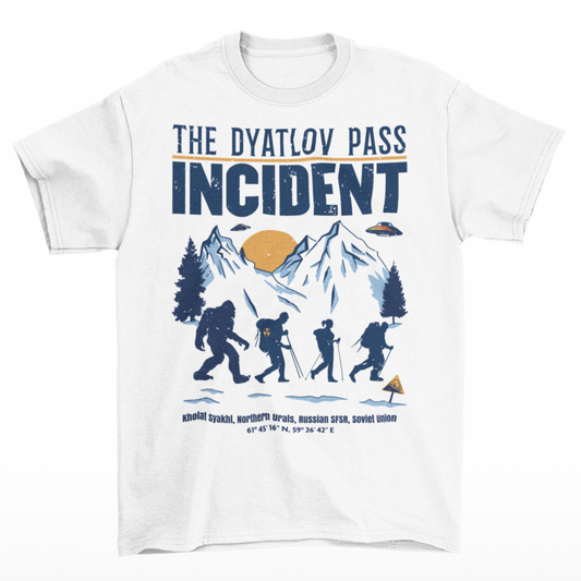 White t-shirt of a group of hikers in snowy mountains with UFOs with Bigfoot on the end of the group with text "THE DYATLOV PASS INCIDENT"