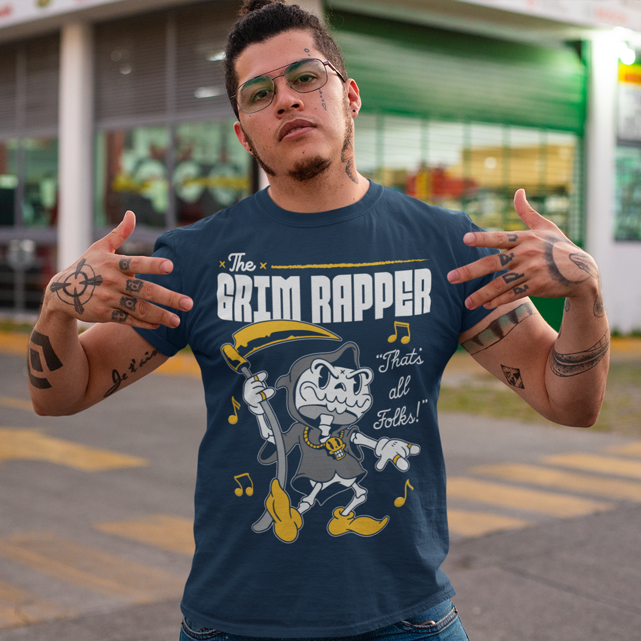 Navy t-shirt of a cartoon rapper grim reaper with musical notes and text above THE GRIM RAPPER